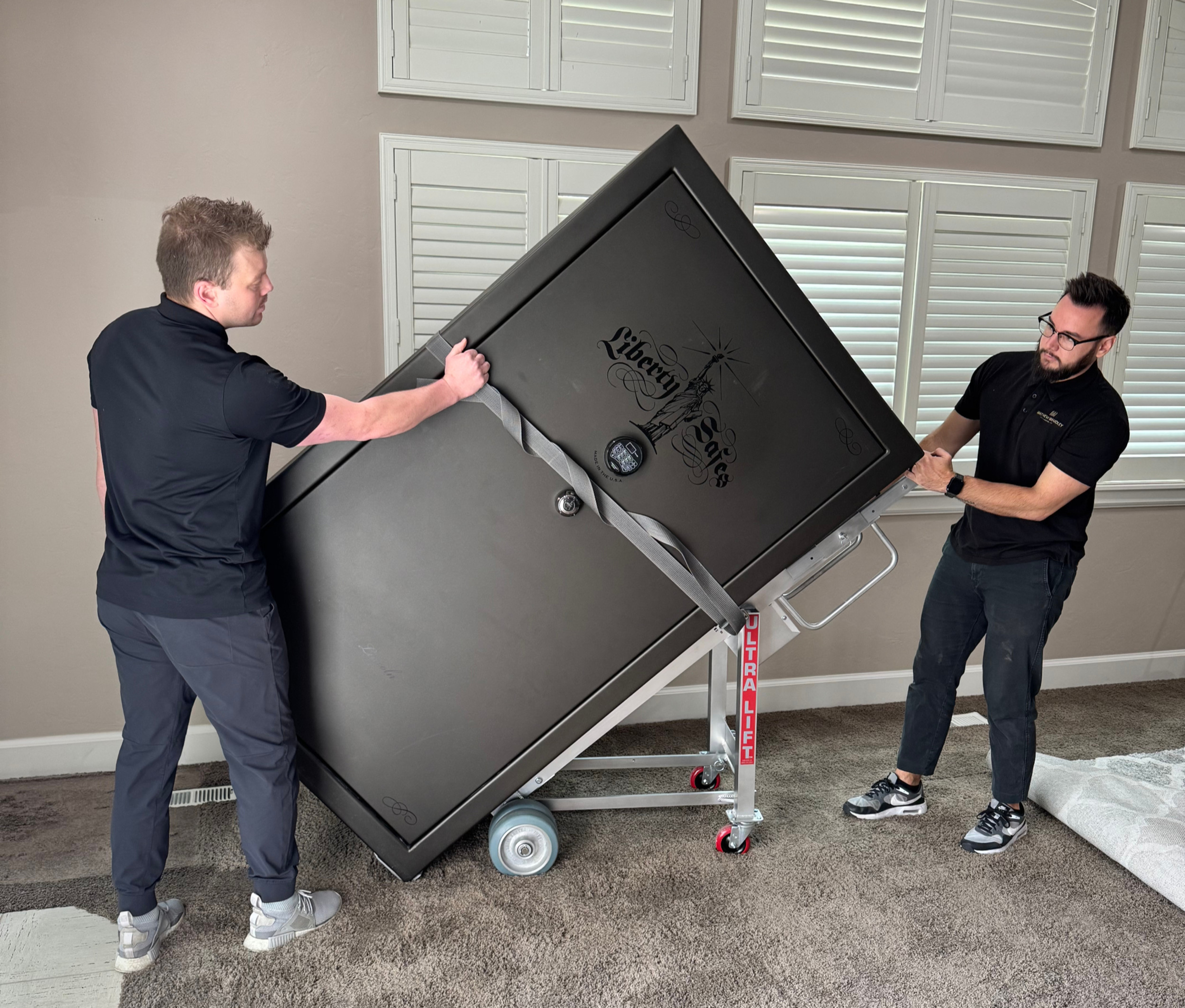 Professional technicians removing a heavy home safe before property settlement